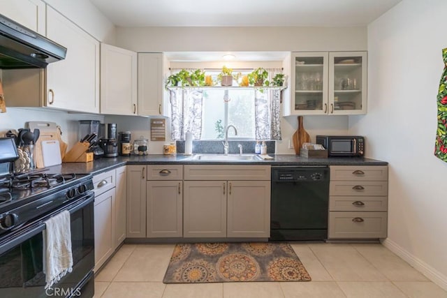 5270 E Anaheim Rd Unit 2, Long Beach, CA 90815 - kitchen with black appliances, a sink, under cabinet range hood, dark countertops, and glass insert cabinets