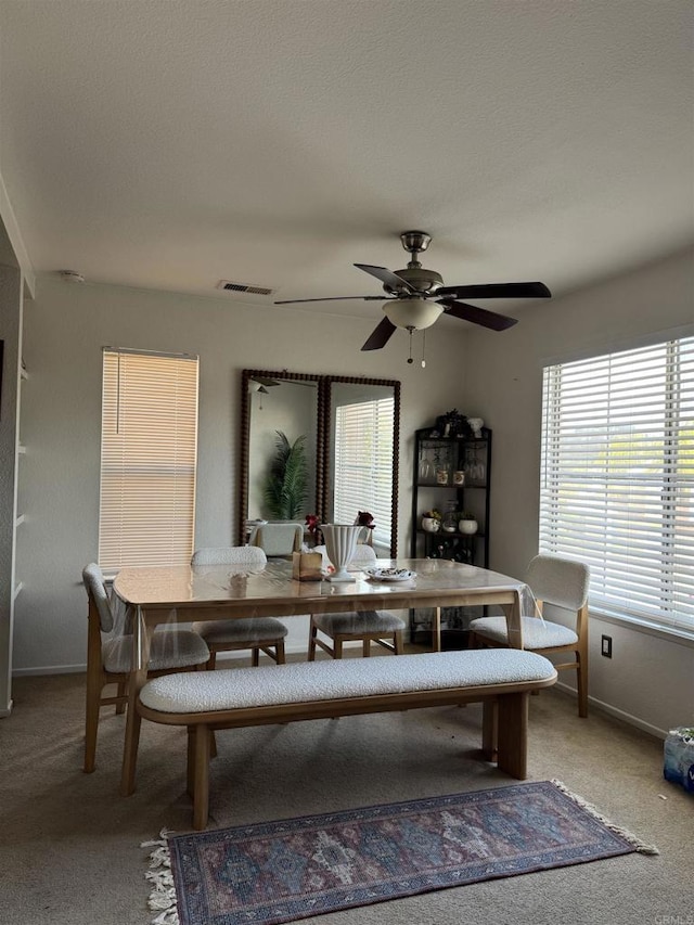 12090 Calle De Montana Unit 251, El Cajon, CA 92019 - dining space with baseboards, visible vents, a ceiling fan, and light carpet
