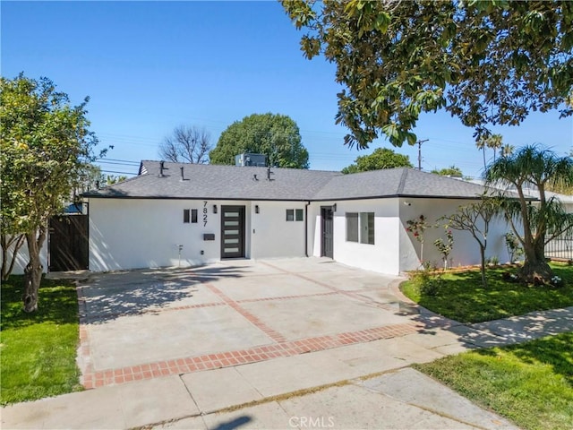 single story home featuring stucco siding, fence, and a shingled roof