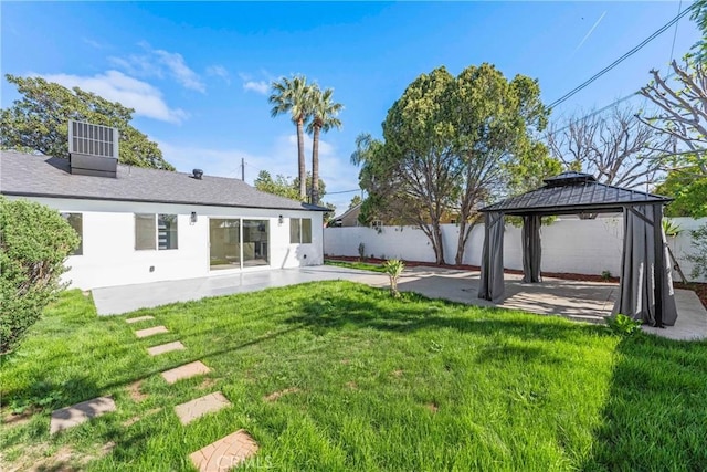 view of yard with a patio area, a gazebo, cooling unit, and fence