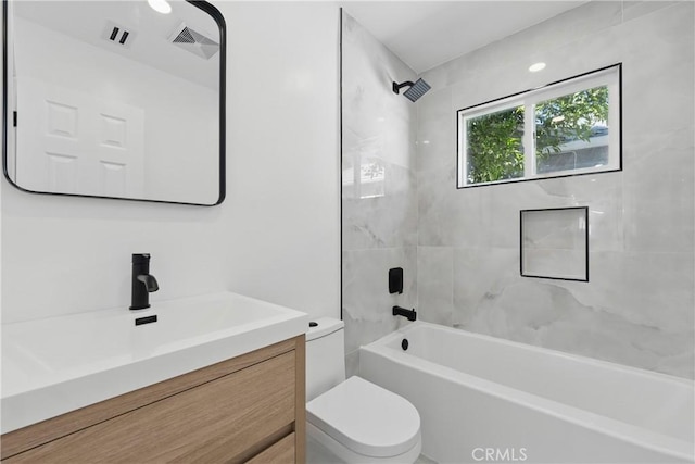 bathroom with visible vents, toilet, vanity, and shower / bathtub combination
