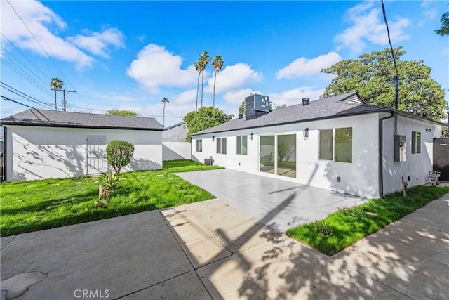 back of property featuring central air condition unit, a chimney, stucco siding, a yard, and a patio area