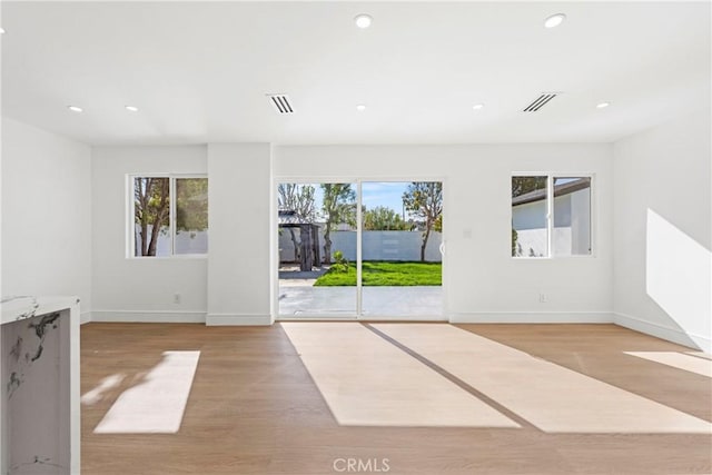 unfurnished room featuring light wood-style flooring, recessed lighting, baseboards, and visible vents