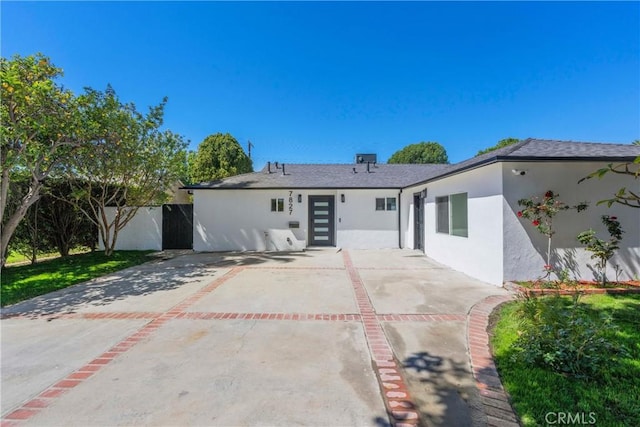 back of house featuring stucco siding, a shingled roof, fence, and a patio