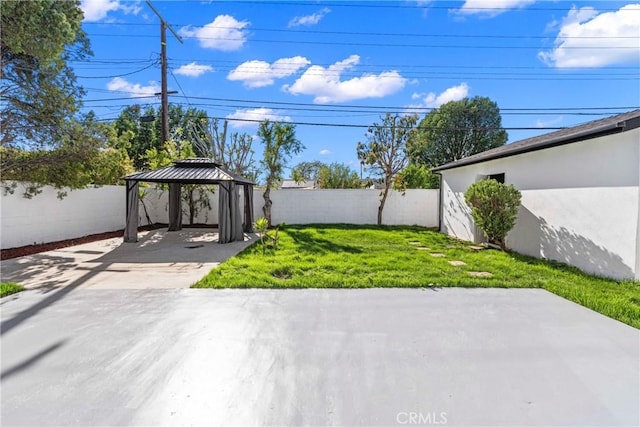 view of yard featuring a fenced backyard, a gazebo, and a patio area