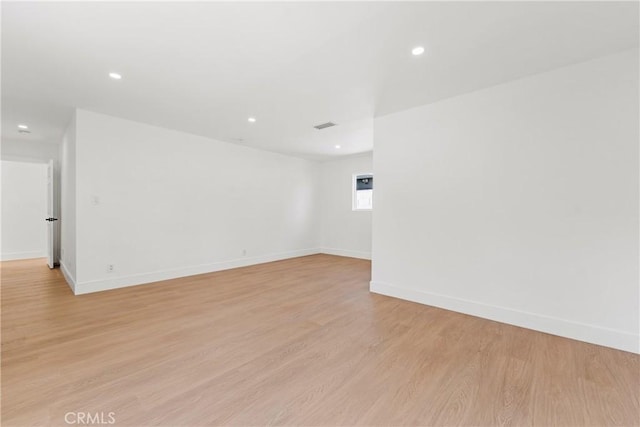 unfurnished room with recessed lighting, baseboards, light wood-style floors, and visible vents