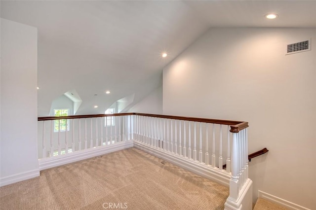 interior space featuring carpet flooring, recessed lighting, visible vents, and lofted ceiling