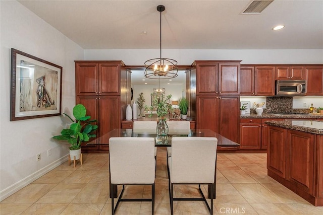 dining room featuring an inviting chandelier, baseboards, light tile patterned flooring, and visible vents