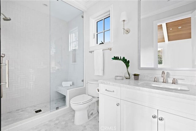 bathroom with toilet, vanity, ornamental molding, and a stall shower