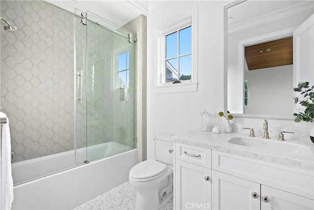 bathroom with combined bath / shower with glass door, toilet, and vanity