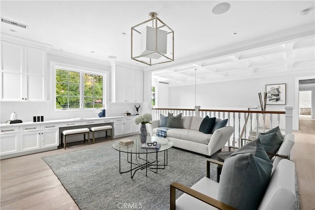 living room with visible vents, beamed ceiling, ornamental molding, light wood-type flooring, and coffered ceiling