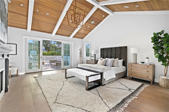 bedroom with hardwood / wood-style floors, wood ceiling, beam ceiling, and access to exterior