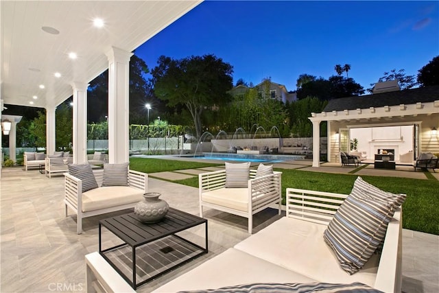 view of patio / terrace with an outdoor living space with a fireplace, fence, and a fenced in pool