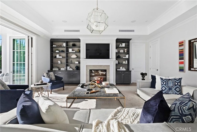living area featuring ornamental molding, a glass covered fireplace, and visible vents