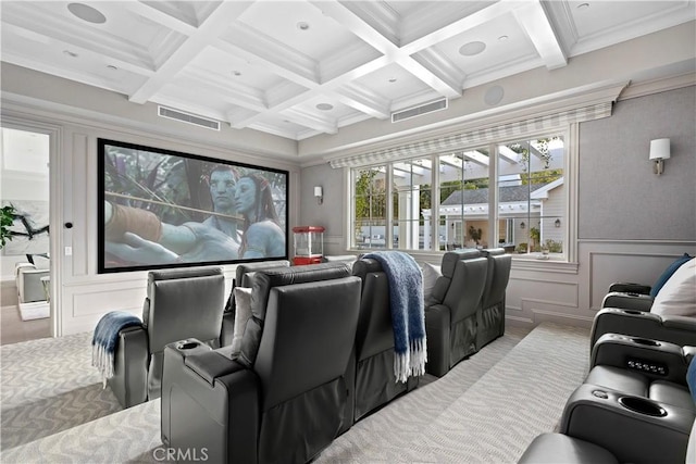carpeted cinema with coffered ceiling, beamed ceiling, visible vents, and ornamental molding