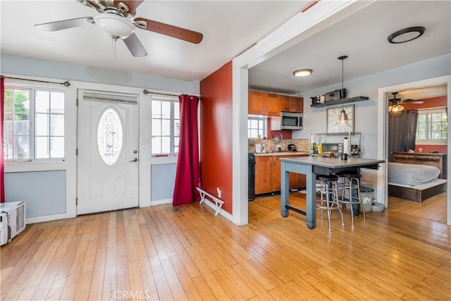1361 W Vernon Ave, Los Angeles, CA 90037 - foyer entrance featuring baseboards, light wood finished floors, and ceiling fan