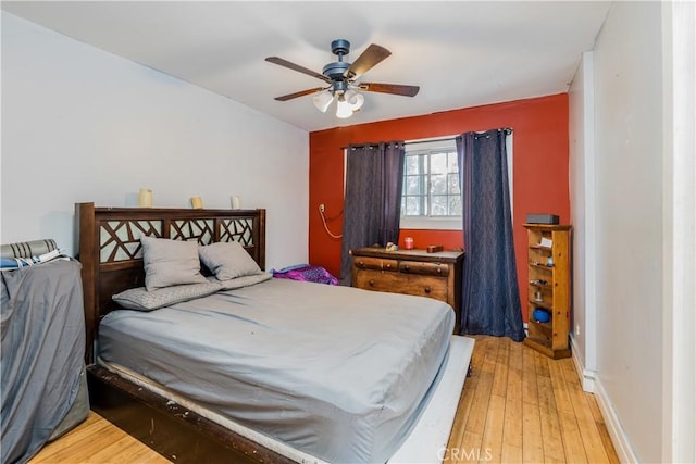 1361 W Vernon Ave, Los Angeles, CA 90037 - bedroom featuring baseboards, light wood-style floors, and a ceiling fan