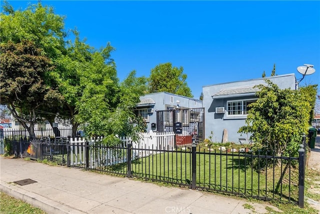 1361 W Vernon Ave, Los Angeles, CA 90037 - view of front of house featuring stucco siding, a front yard, and a fenced front yard