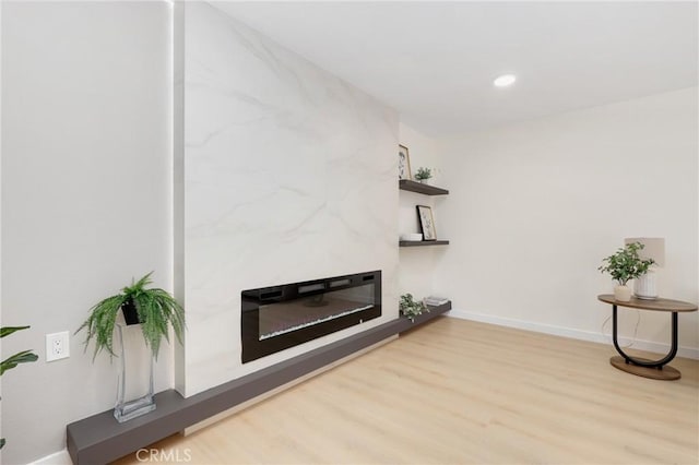 2405 Via Mariposa W Unit 1B, Laguna Woods, CA 92637 - unfurnished living room with wood finished floors, baseboards, recessed lighting, and a high end fireplace