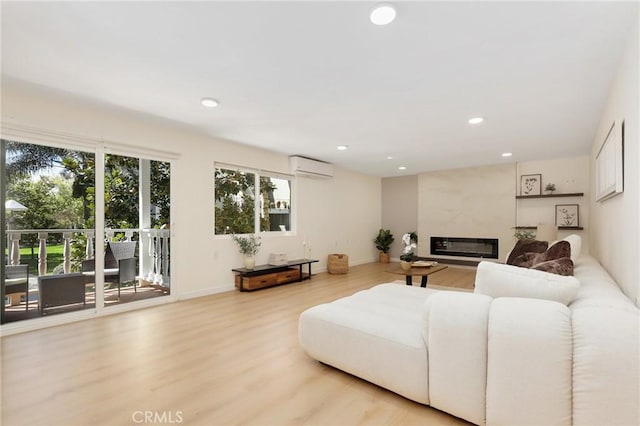 2405 Via Mariposa W Unit 1B, Laguna Woods, CA 92637 - living area featuring a wall mounted air conditioner, light wood-type flooring, a high end fireplace, recessed lighting, and baseboards