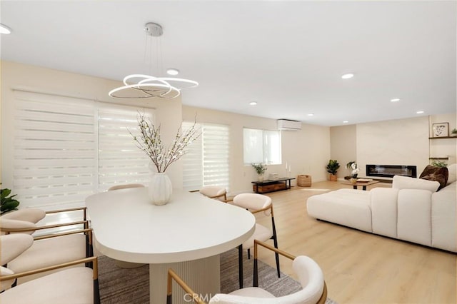 2405 Via Mariposa W Unit 1B, Laguna Woods, CA 92637 - living area featuring an AC wall unit, wood finished floors, a chandelier, and recessed lighting