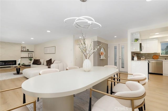 2405 Via Mariposa W Unit 1B, Laguna Woods, CA 92637 - dining room featuring light wood-style flooring, recessed lighting, a fireplace, and a chandelier