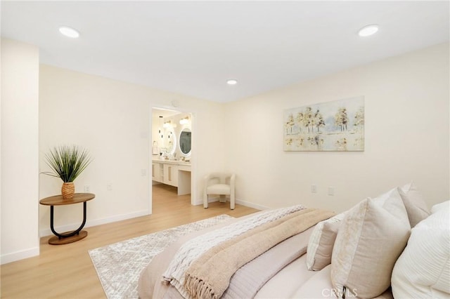 2405 Via Mariposa W Unit 1B, Laguna Woods, CA 92637 - bedroom with light wood-style flooring, baseboards, recessed lighting, and connected bathroom