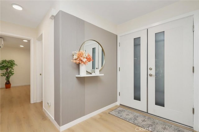 2405 Via Mariposa W Unit 1B, Laguna Woods, CA 92637 - entrance foyer with wood finished floors, baseboards, recessed lighting, and a wall mounted air conditioner