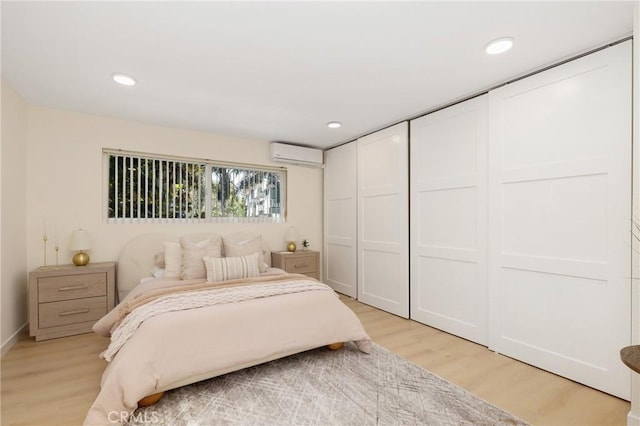 2405 Via Mariposa W Unit 1B, Laguna Woods, CA 92637 - bedroom with an AC wall unit, light wood-style floors, recessed lighting, and baseboards