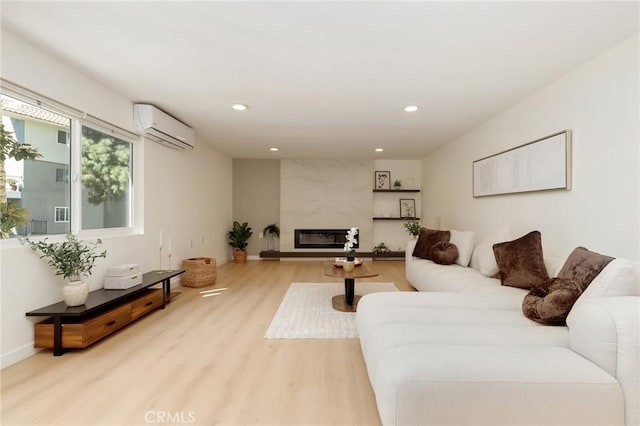2405 Via Mariposa W Unit 1B, Laguna Woods, CA 92637 - living room with a wall unit AC, wood finished floors, recessed lighting, baseboards, and a premium fireplace