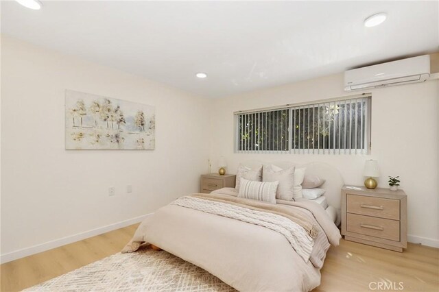 2405 Via Mariposa W Unit 1B, Laguna Woods, CA 92637 - bedroom with a wall unit AC, light wood-type flooring, baseboards, and recessed lighting