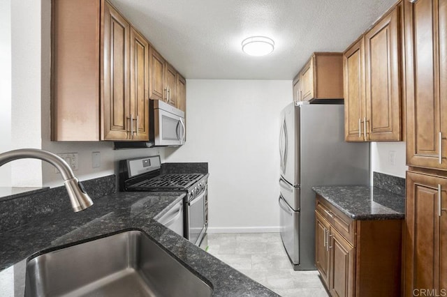 11365 Affinity Ct Unit 192, San Diego, CA 92131 - kitchen featuring stainless steel appliances, brown cabinets, and a textured ceiling