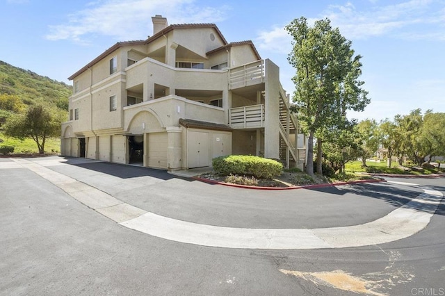 11365 Affinity Ct Unit 192, San Diego, CA 92131 - view of property featuring an attached garage, driveway, and stairs