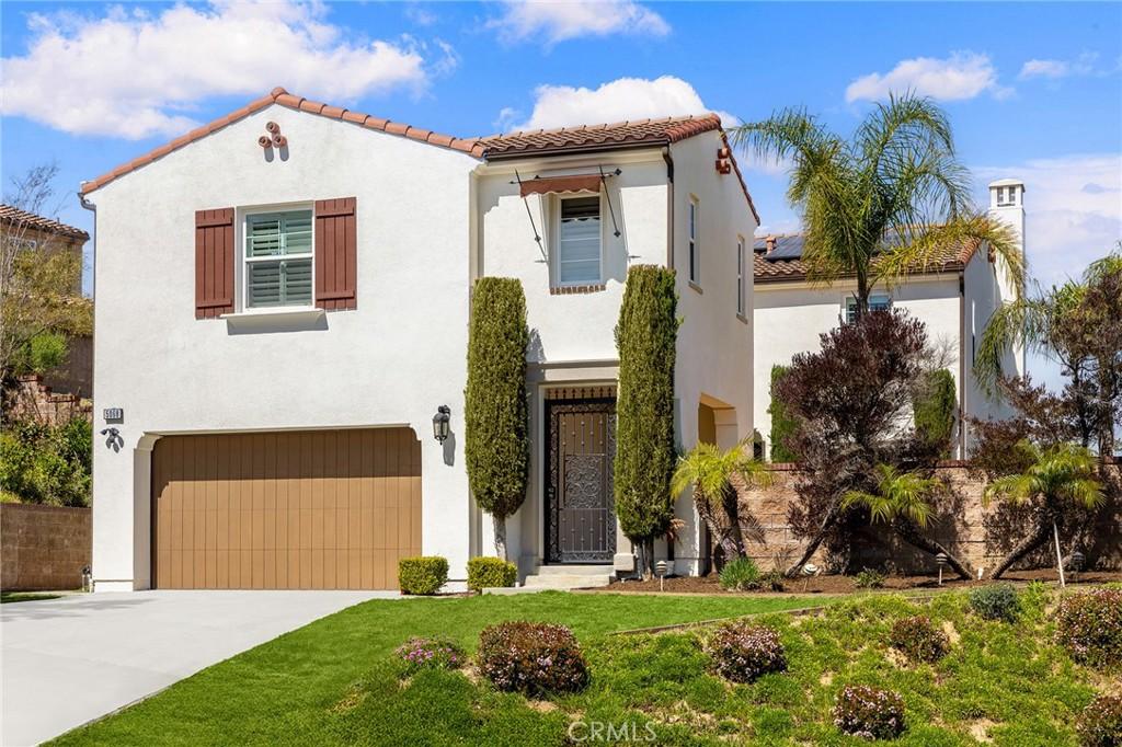 5068 Highview St, Chino Hills, CA 91709 - mediterranean / spanish home with stucco siding, a tiled roof, driveway, a front lawn, and a garage