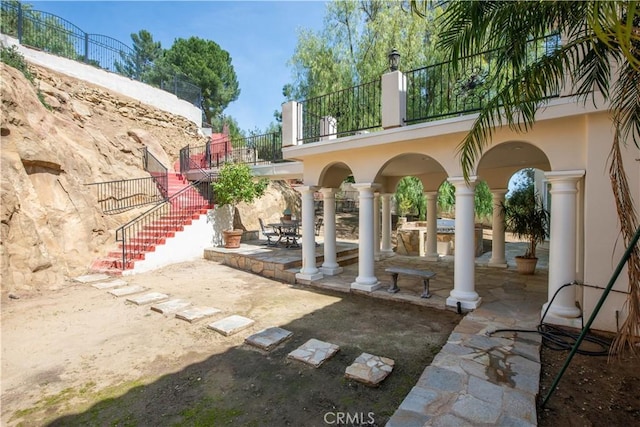 22751 Plummer St, Chatsworth, CA 91311 - view of patio featuring a balcony and stairway
