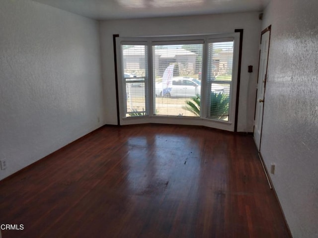 1420 S Butler Ave, Compton, CA 90221 - unfurnished room with wood finished floors and a textured wall