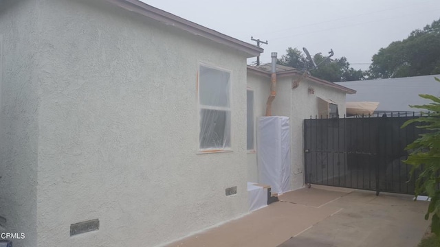 1420 S Butler Ave, Compton, CA 90221 - view of home's exterior with stucco siding and a gate