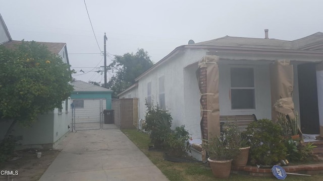 1420 S Butler Ave, Compton, CA 90221 - view of home's exterior featuring a gate, concrete driveway, and a shingled roof