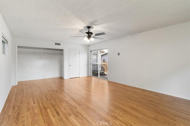 interior space featuring visible vents, light wood-style flooring, ceiling fan, and a textured ceiling