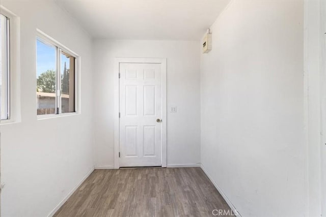 empty room with baseboards and wood finished floors