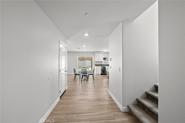 1772 Old Wagon Dr, Hemet, CA 92545 - corridor with baseboards, light wood-style flooring, and stairs