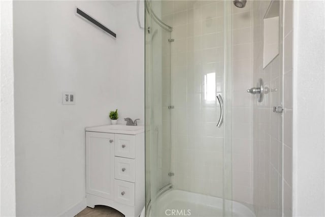 full bathroom with a tile shower and a sink