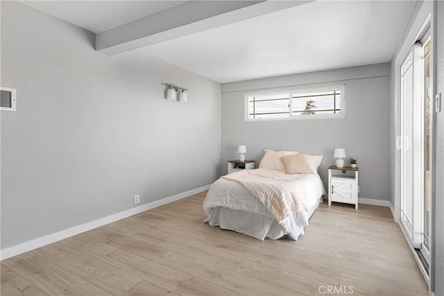 bedroom with baseboards, visible vents, and light wood-style floors