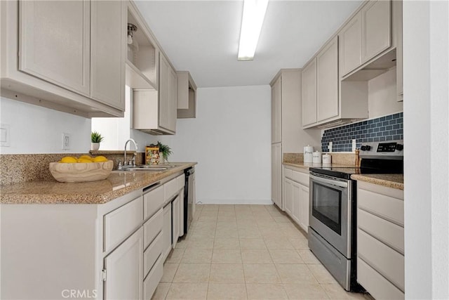 kitchen featuring electric range, light countertops, a sink, backsplash, and light tile patterned floors