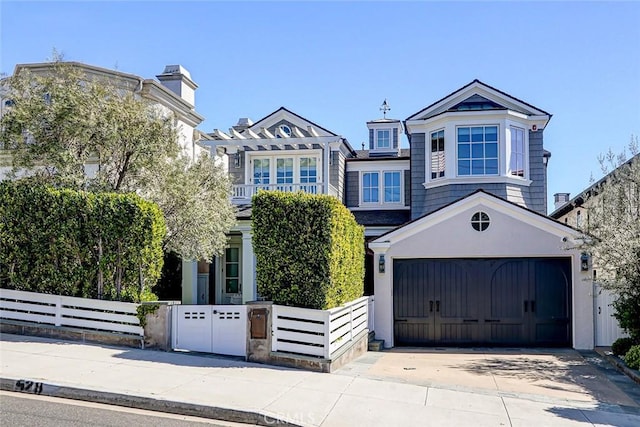 528 15th St, Manhattan Beach, CA 90266 - view of front of home with concrete driveway, a fenced front yard, and an attached garage