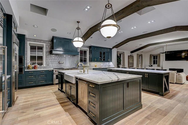 528 15th St, Manhattan Beach, CA 90266 - kitchen with a center island with sink, a sink, lofted ceiling with beams, and tasteful backsplash