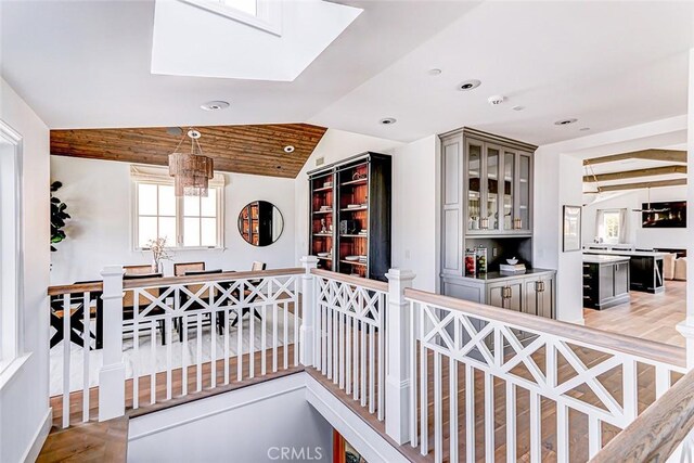 528 15th St, Manhattan Beach, CA 90266 - interior space with gray cabinets, vaulted ceiling with skylight, wood finished floors, glass insert cabinets, and recessed lighting