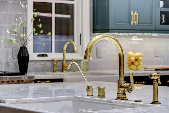 528 15th St, Manhattan Beach, CA 90266 - details featuring light stone countertops, a sink, and blue cabinetry