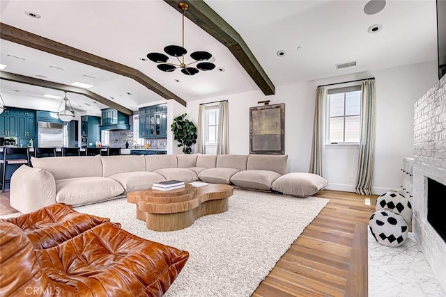 528 15th St, Manhattan Beach, CA 90266 - living room featuring visible vents, beamed ceiling, baseboards, a fireplace, and a notable chandelier