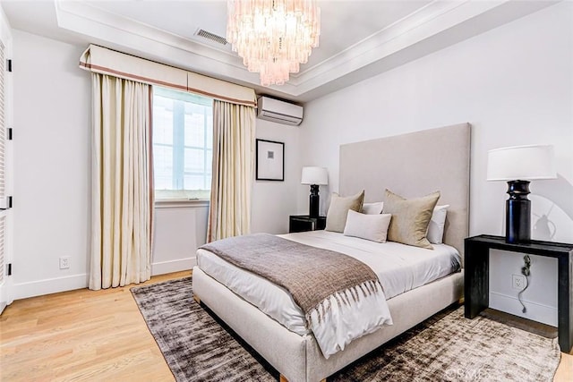 528 15th St, Manhattan Beach, CA 90266 - bedroom featuring a chandelier, baseboards, wood finished floors, a tray ceiling, and a wall unit AC